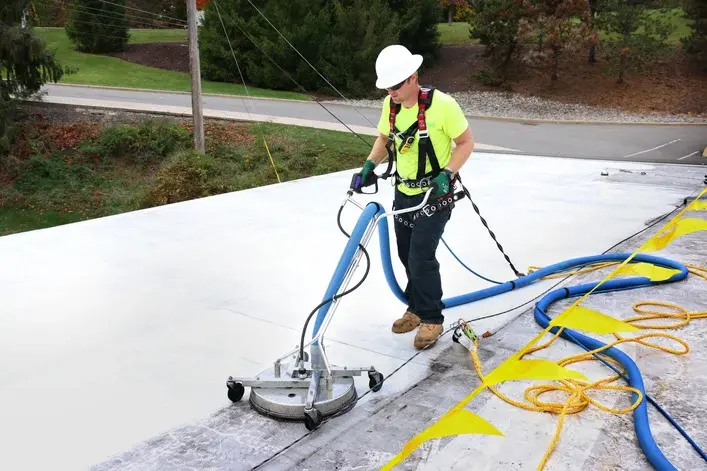 Worker using equipment on rooftop
