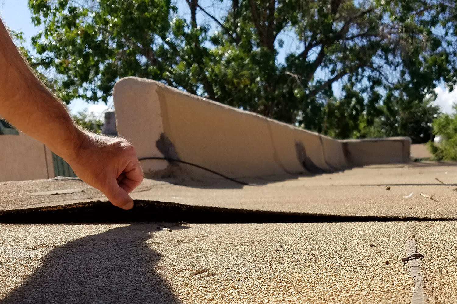 Lifted roof seam during roof inspection.