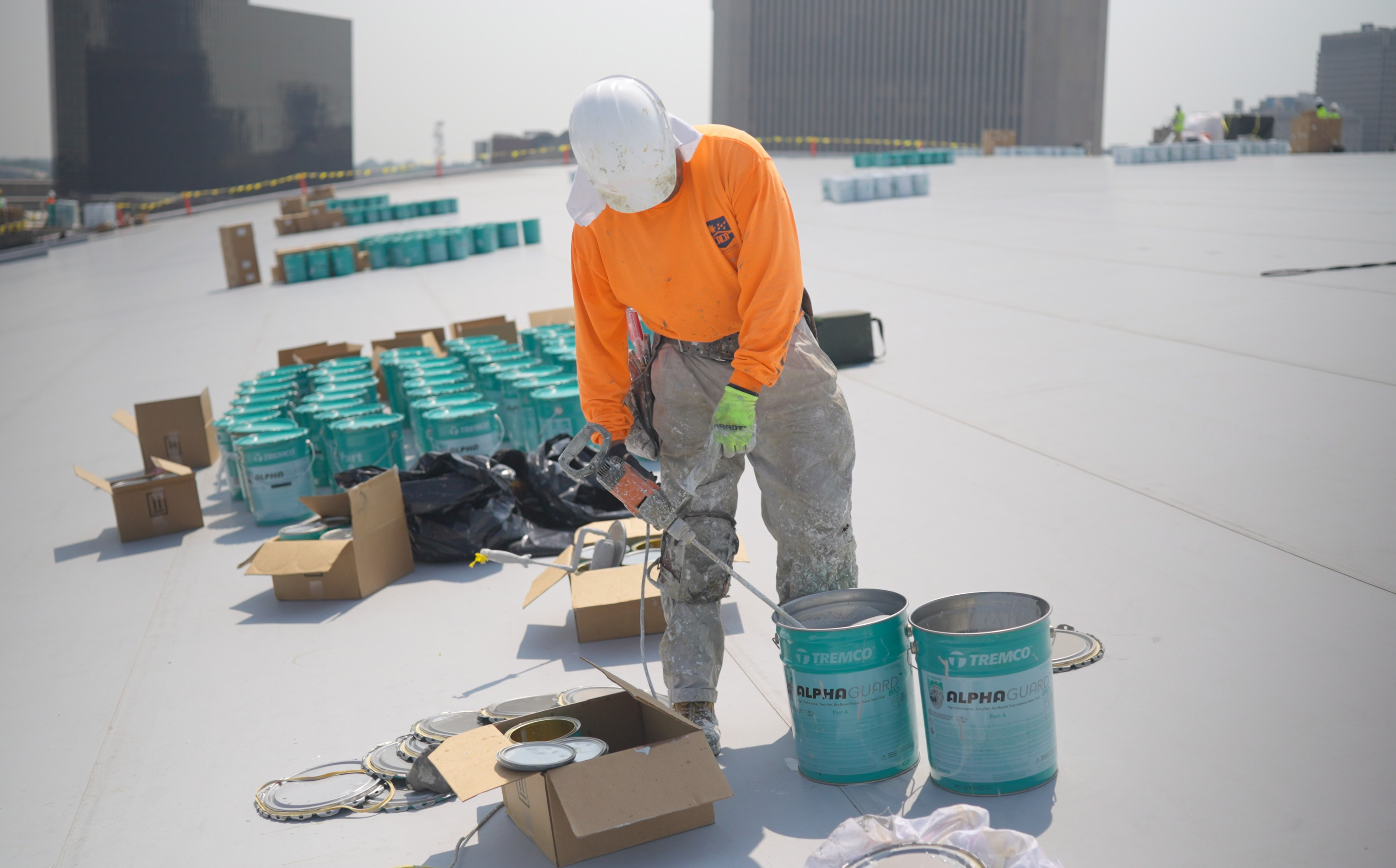 Roofer mixing AlphaGuard roof membrane.