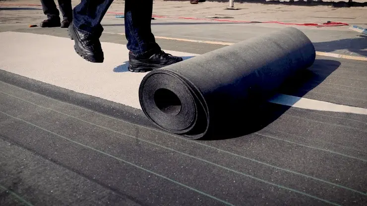 Worker installing roofing material