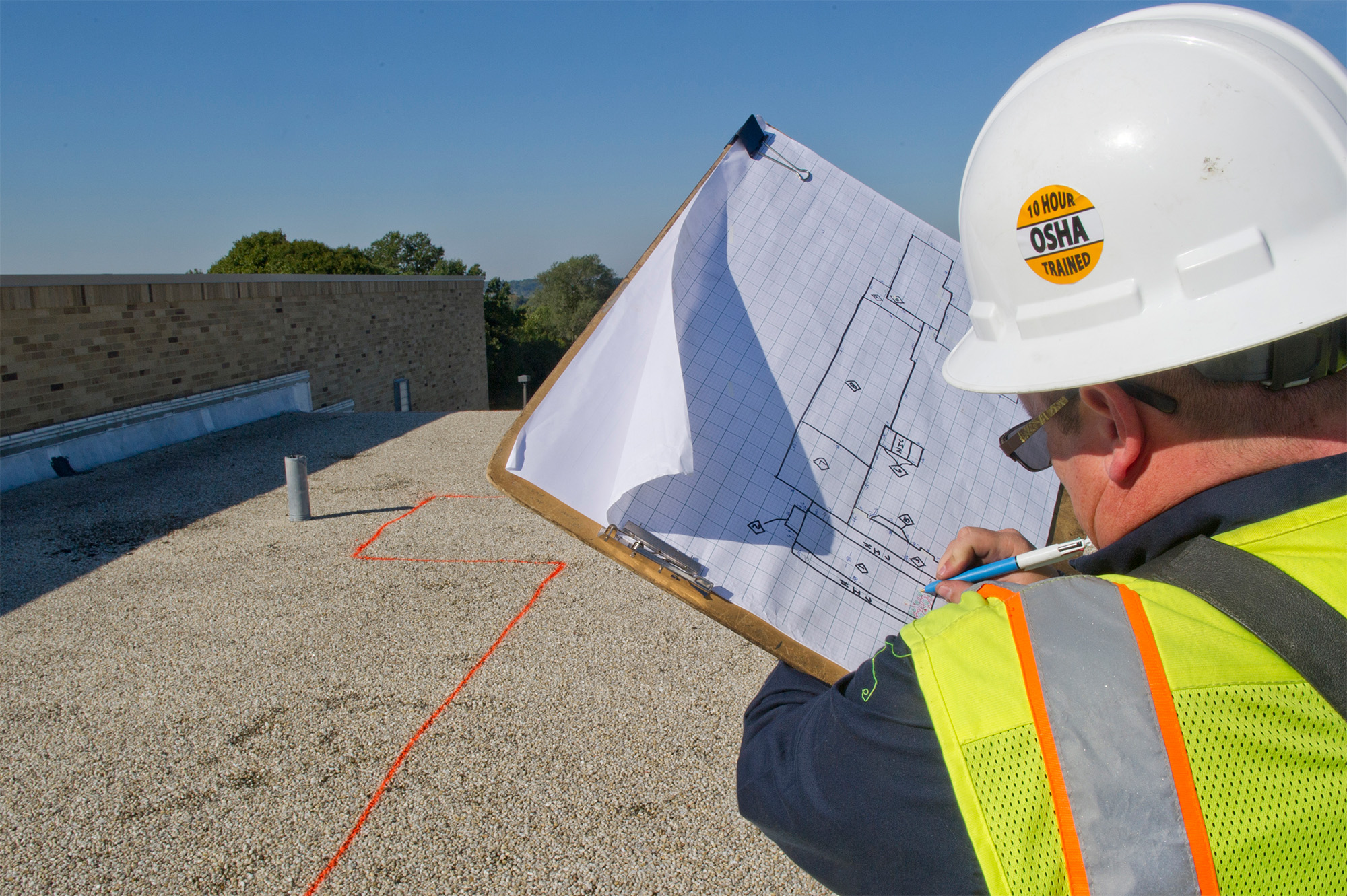 Engineer conducting roof analysis.