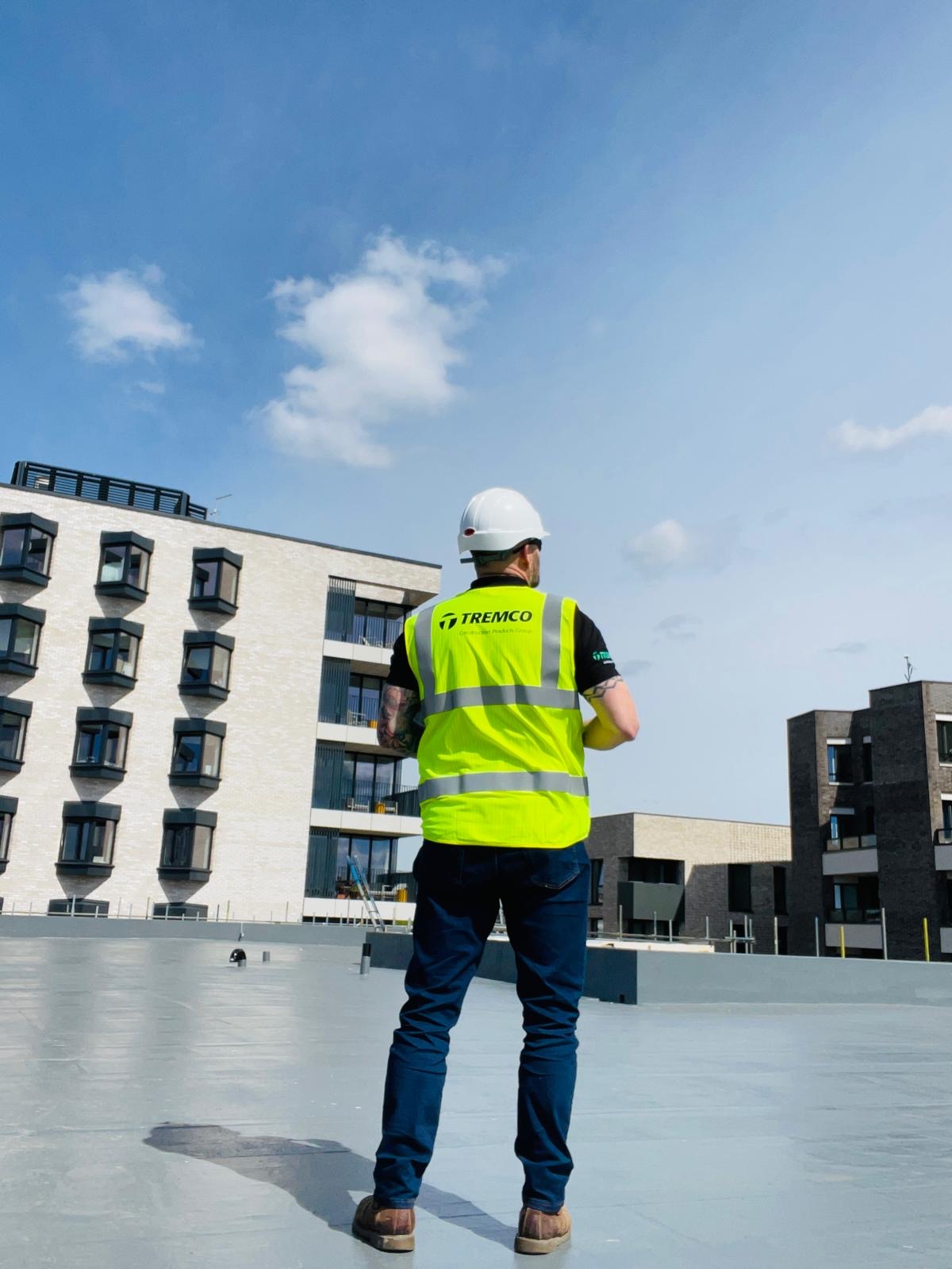 Tremco worker standing on a roof.