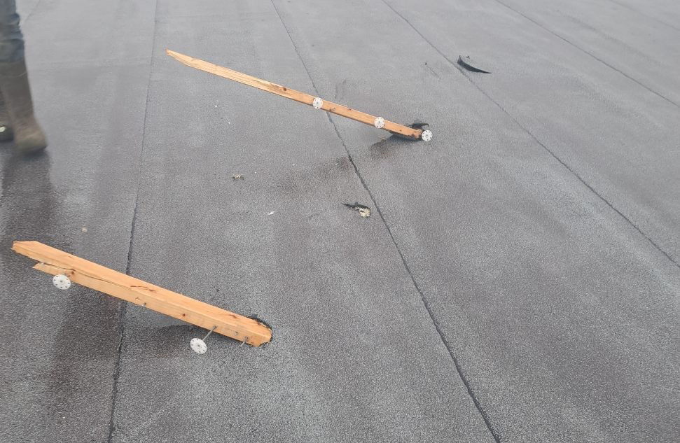 Impact damage to roof from storm.
