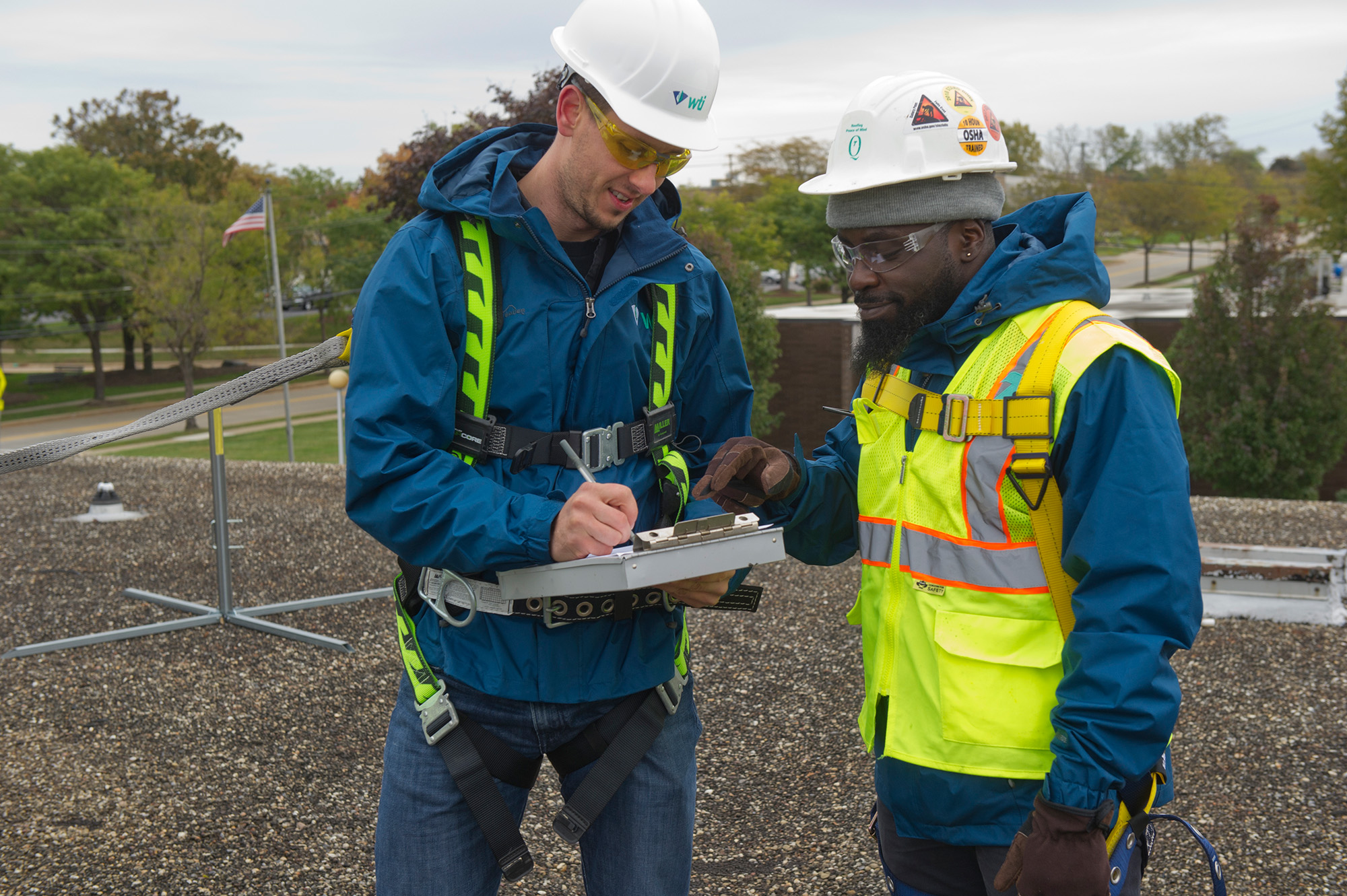 Two construction workers talking over a blueprint.