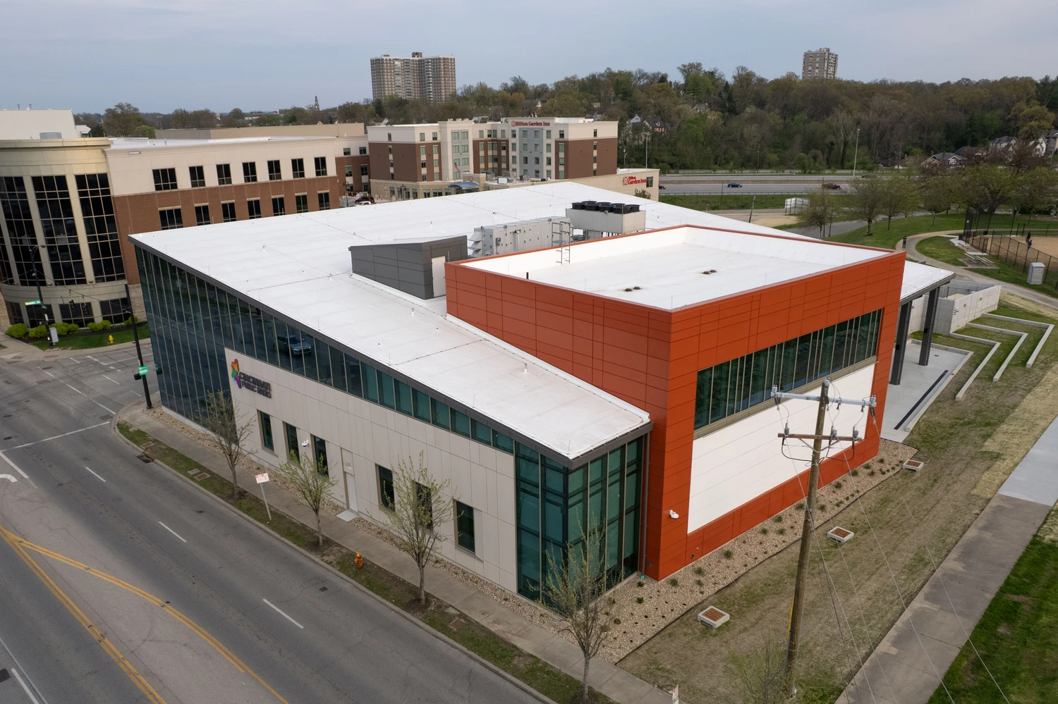 Exterior of glass building with white roof.